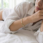 Person wearing a bracelet with a blurred background