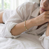 Person wearing a bracelet with a blurred background