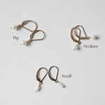 hree pairs of Olivia Pearl Earrings showcasing size variations in freshwater pearls