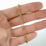 Gold chain bracelet on a hand with a white background