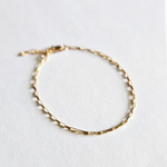 Zoom-in on gold chain texture highlighting dainty finish"
