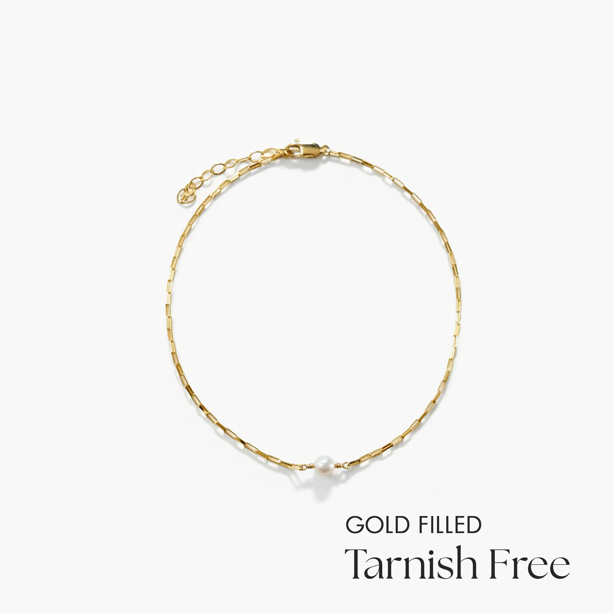 Gold-filled necklace with a pearl on a white background