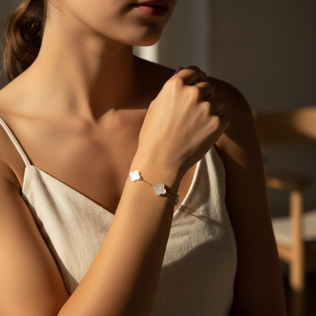 Woman wearing 3 clover shaped pendant bracelet with a blurred background