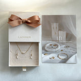 Jewelry set in a box with a bow, featuring the brand 'LAONDRIM'.