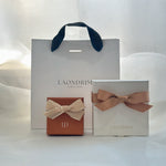 Laondrim jewelry boxes with ribbons on a white background