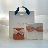 Laondrim jewelry boxes with ribbons on a white background