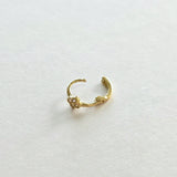 Backside of 14K gold hoop earring with polished clasp and clover charm detail