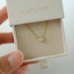 Gold necklace with a diamond pendant in a 'LAONDRIM' box