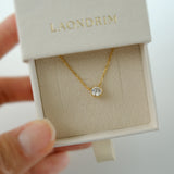 Gold necklace with a diamond pendant in a 'LAONDRIM' box