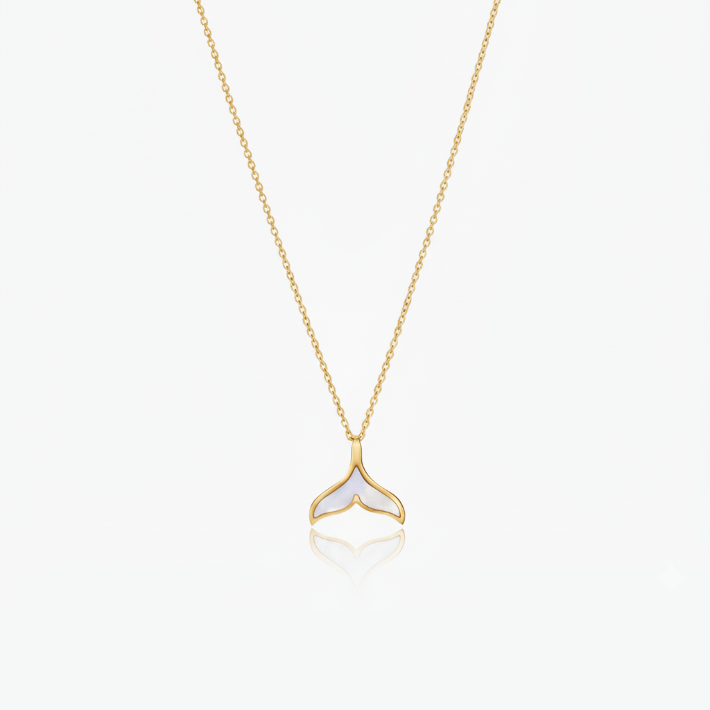 Gold necklace with a whale tail pendant on a white background
