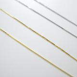 Gold and silver chains on a white background
