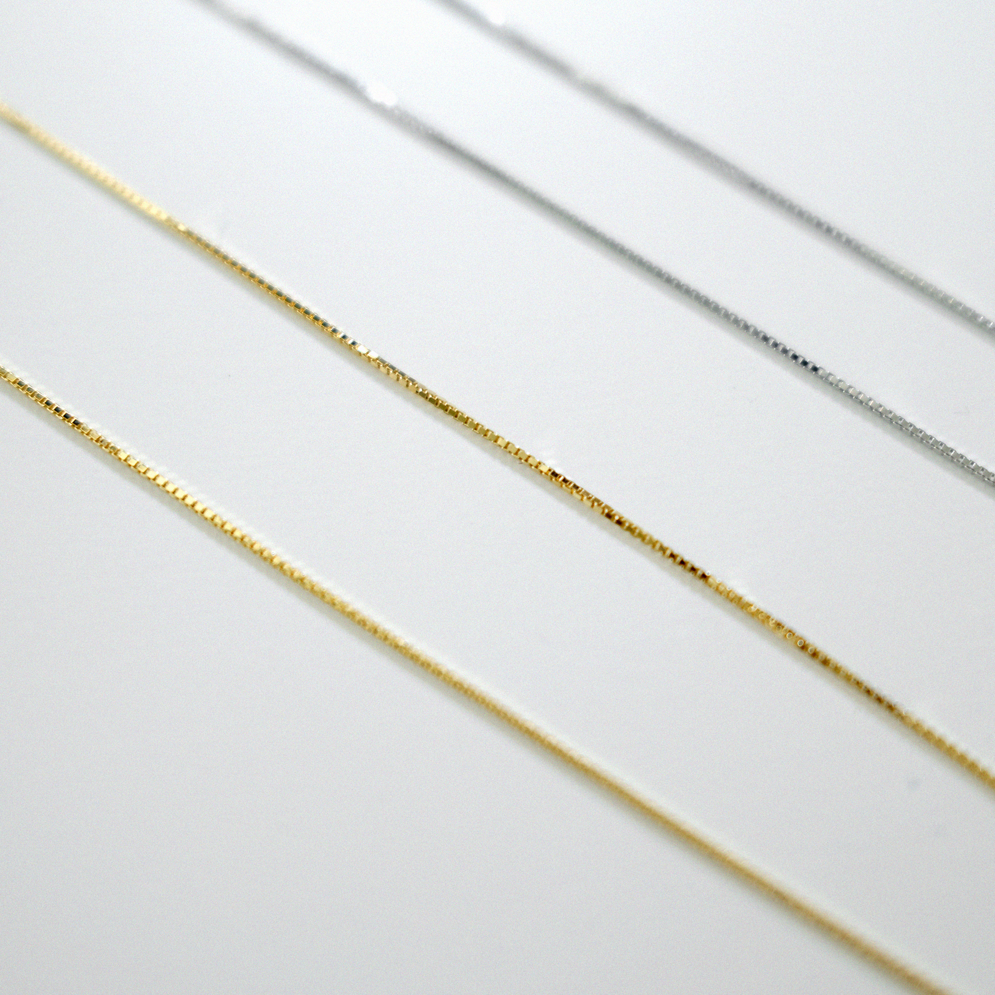 Gold and silver chains on a white background