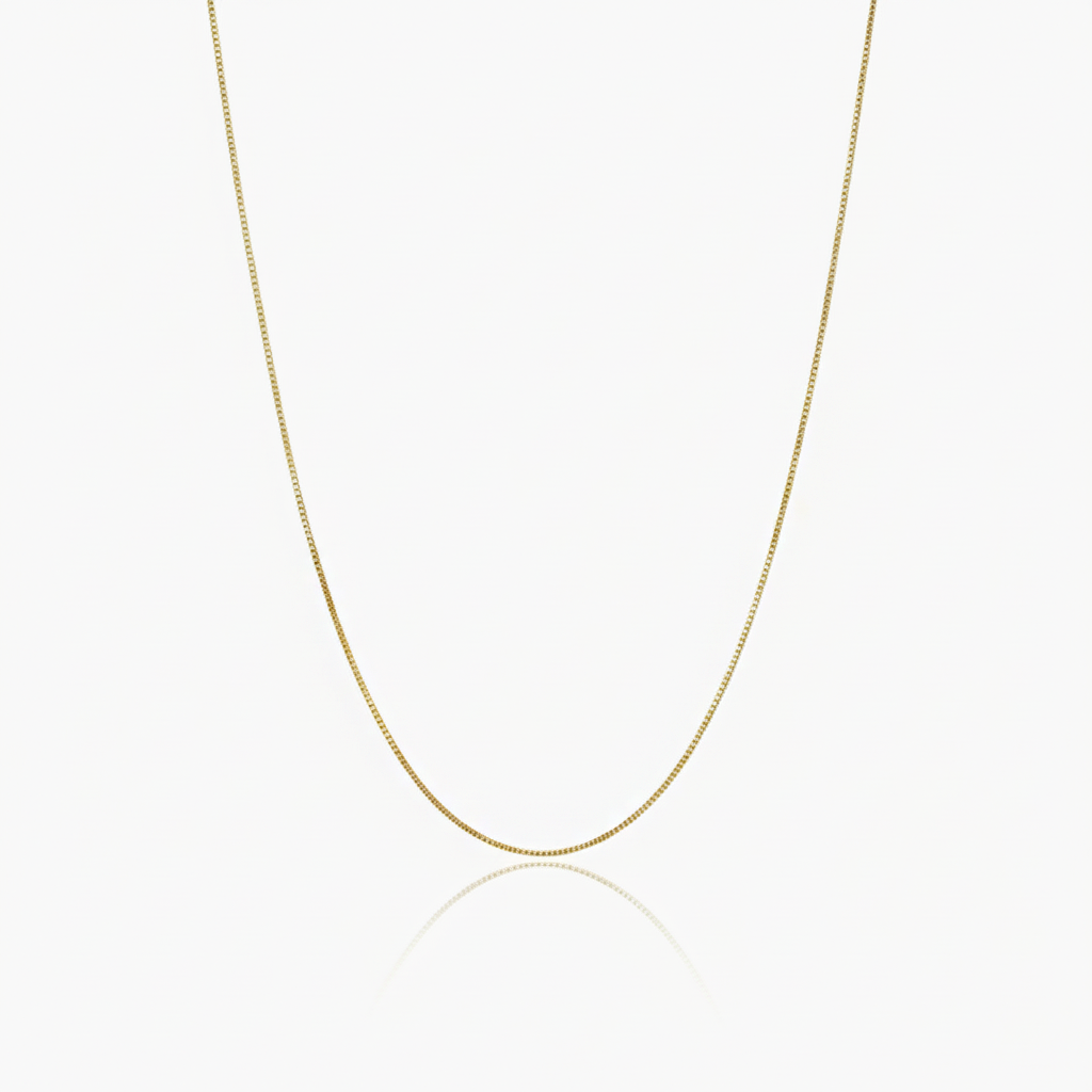 Gold box chain necklace on a white background