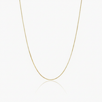 Gold box chain necklace on a white background