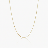 Gold box chain necklace on a white background