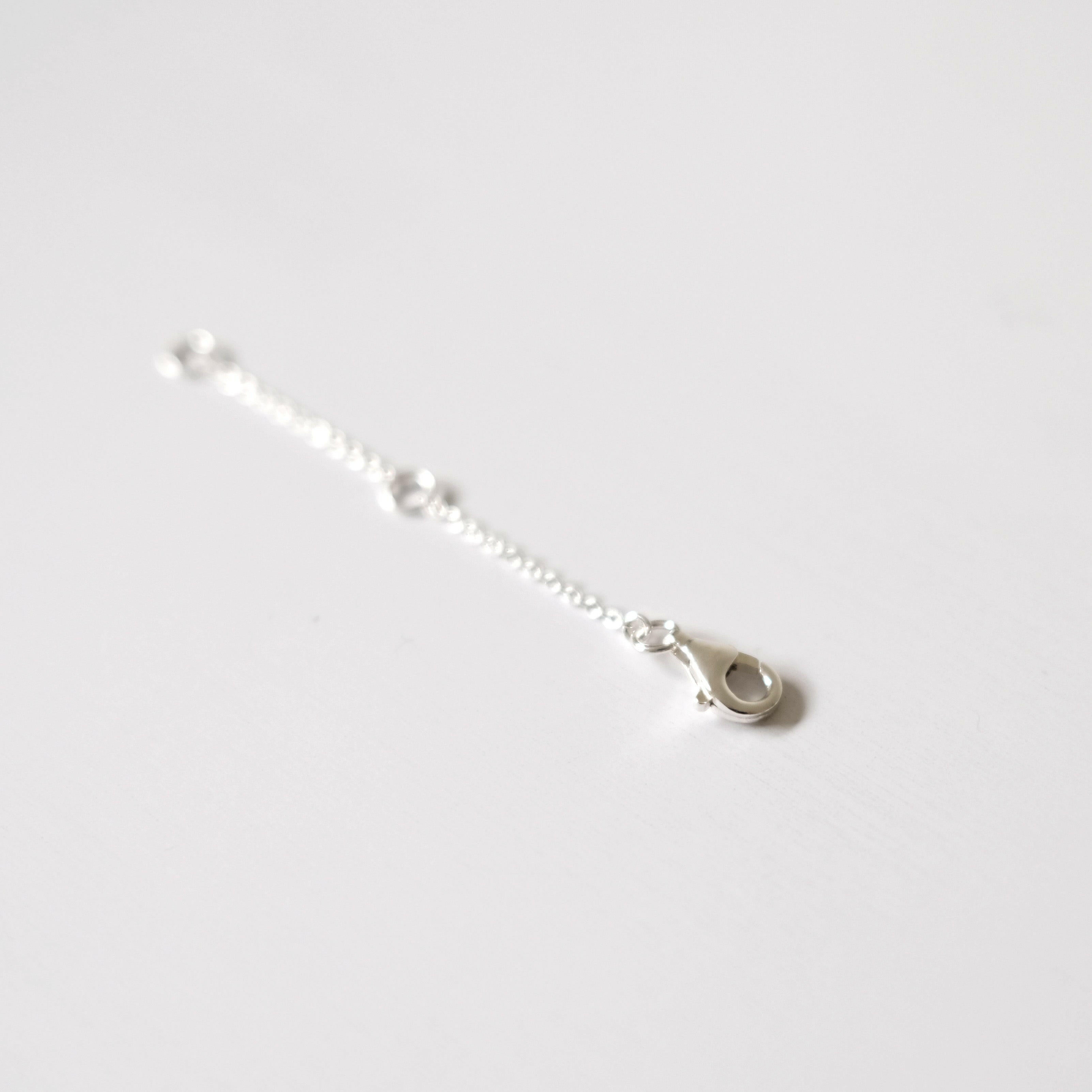 Detailed view of 14K gold vermeil chain extender showing smooth clasp finish