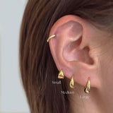 Gold earrings displayed on an ear with 'Small', 'Medium', and 'Large' labels.