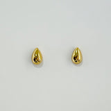 Gold teardrop earrings on a light gray background