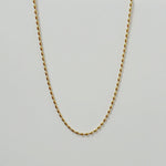 Close-up of Vienna Necklace’s pill-shaped chain design on a white background.