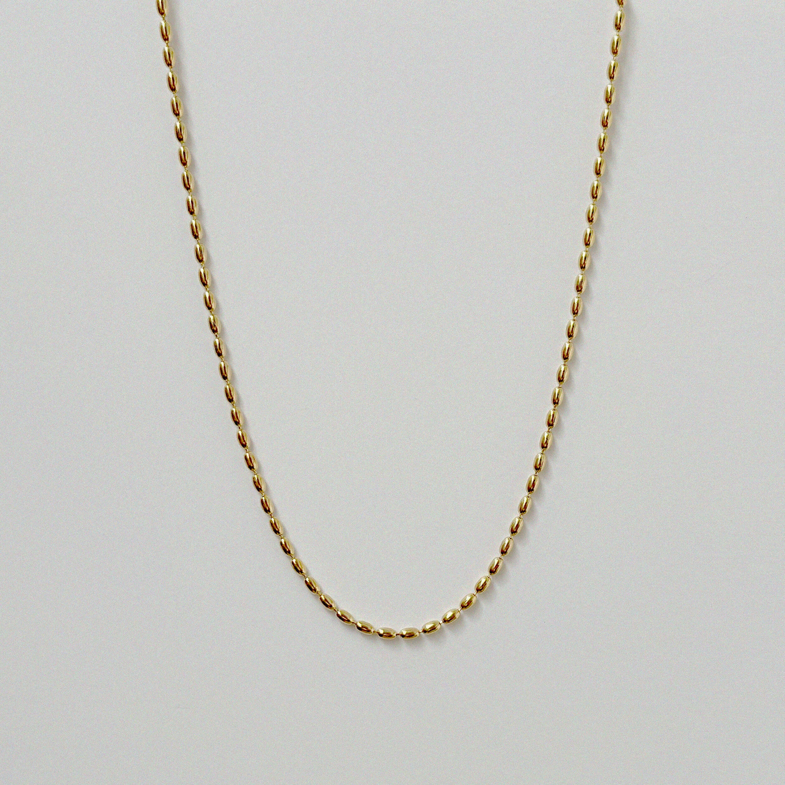 Close-up of Vienna Necklace’s pill-shaped chain design on a white background.