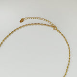 Close-up of interlocking 3D-oval-shaped links in gold, capturing texture and polish