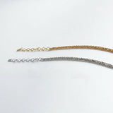 Two gold and silver bracelets on a white background