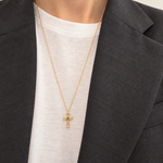Eden Cross Necklace worn with a white top and charcoal blazer