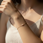 Woman wearing a delicate bracelet on her wrist with a soft focus background