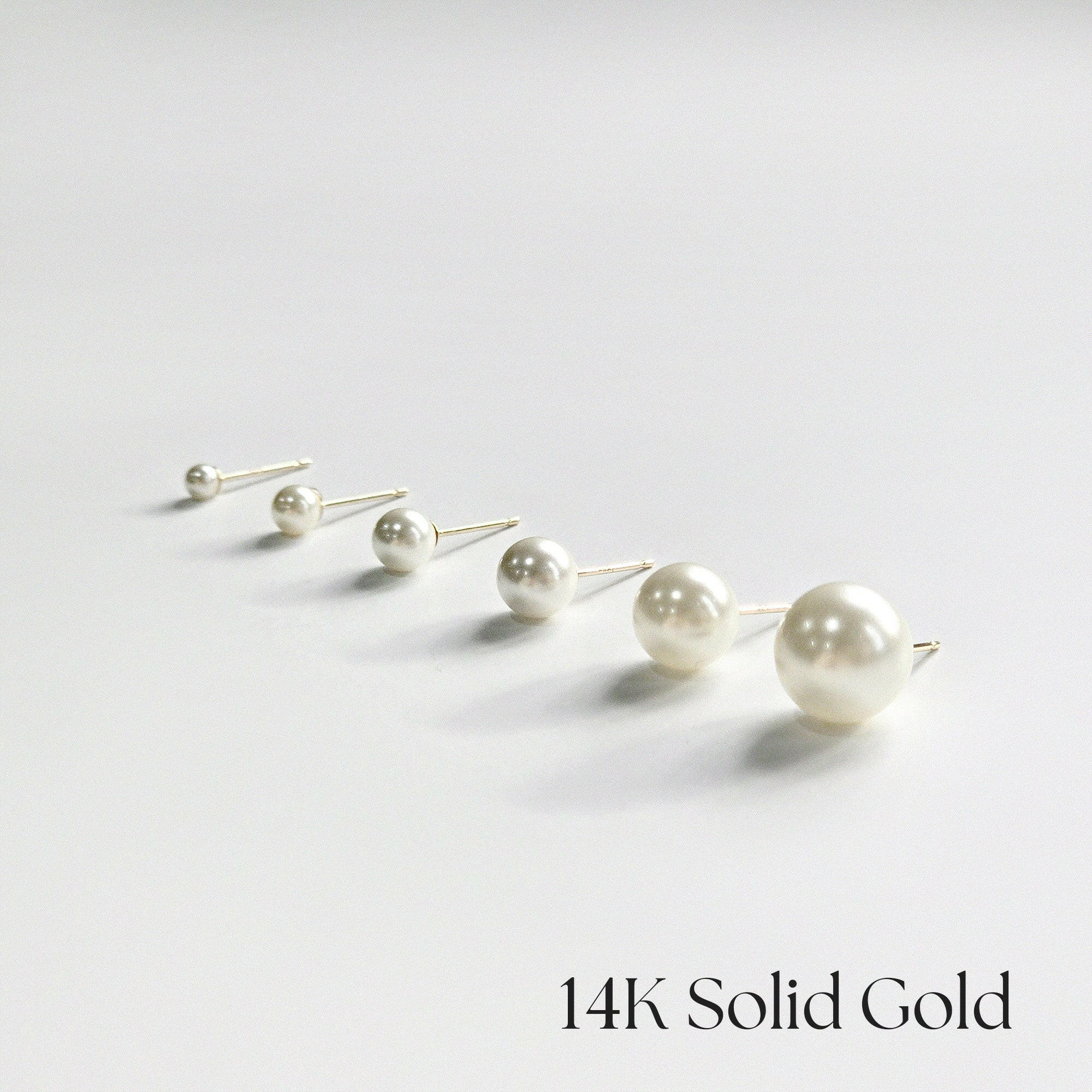Side angle of 14K gold pearl studs in 6 different sizes showcasing depth and setting