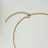 Macro shot of clasp and thick chain link on gold Basa Necklace