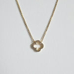 Macro shot of cubic zirconia clover charm showing faceted crystal details