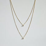 Petite Crystal Double Chain Necklace in gold displayed in a soft curve with double-layered chains