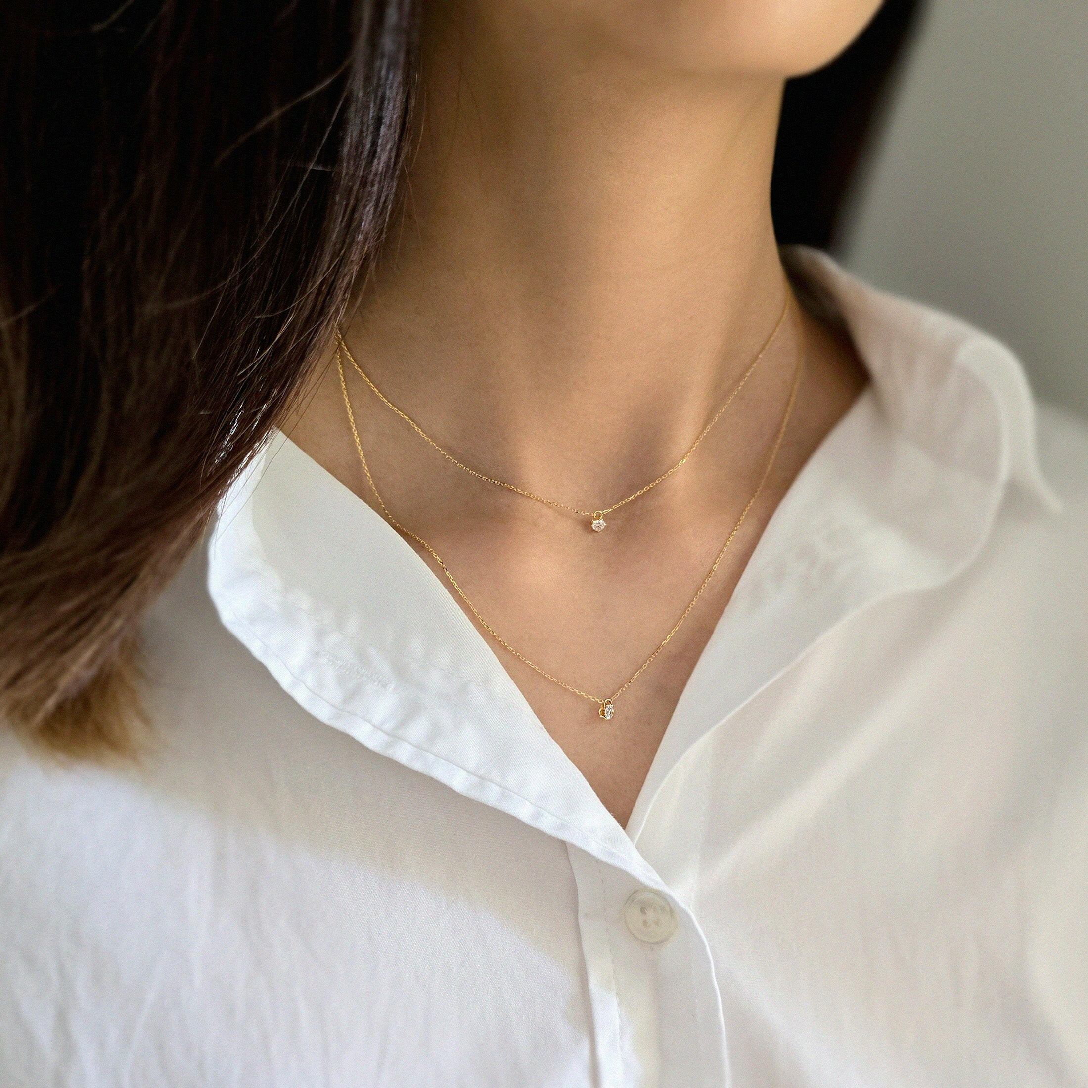 Model wearing double chain necklace for an effortless layered look