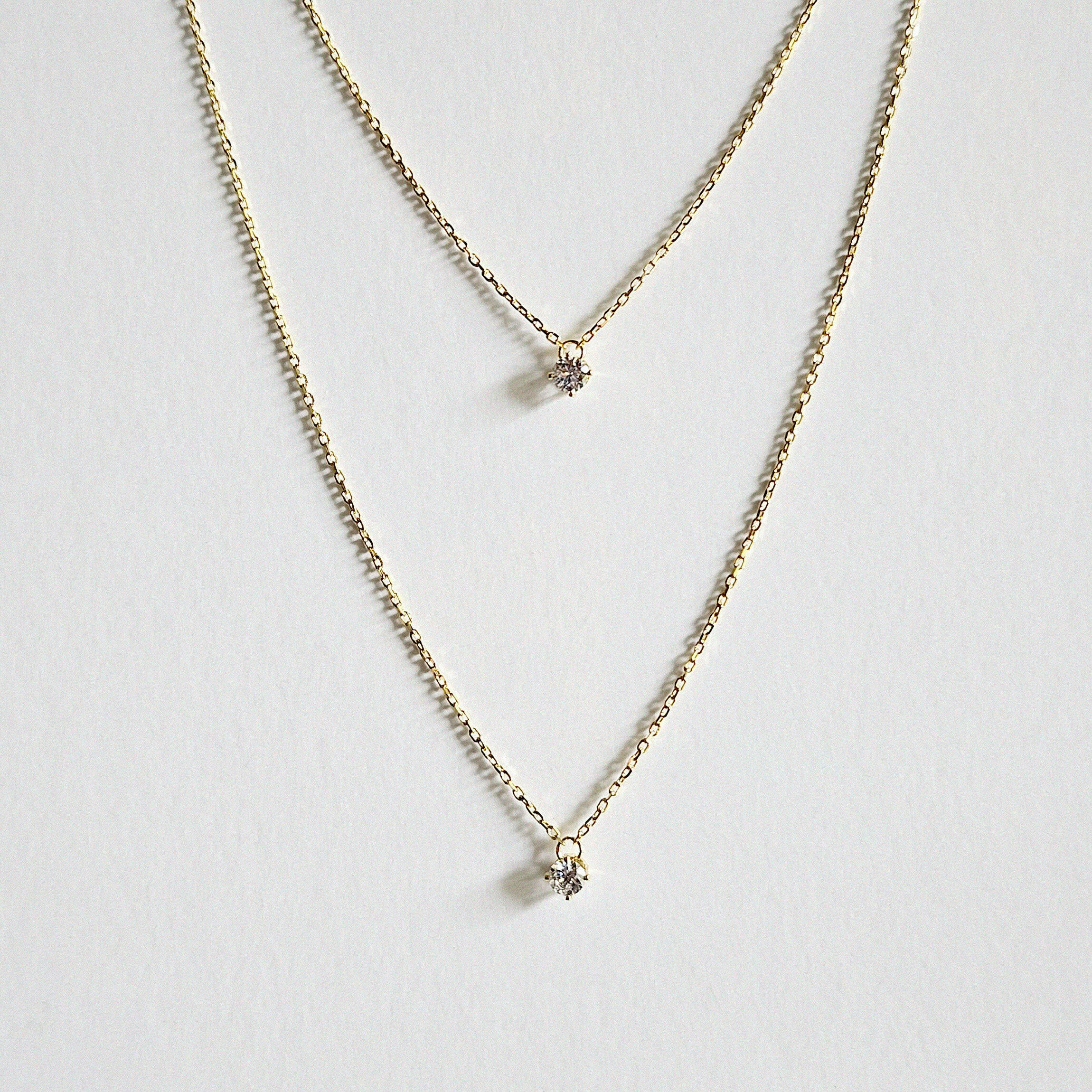 Close-up of crystal pendant between two chains arranged neatly