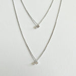 Petite Crystal Double Chain Necklace in silver displayed in a soft curve with double-layered chains