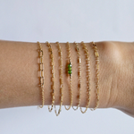Model wearing multiple of minimal gold filled chain bracelet