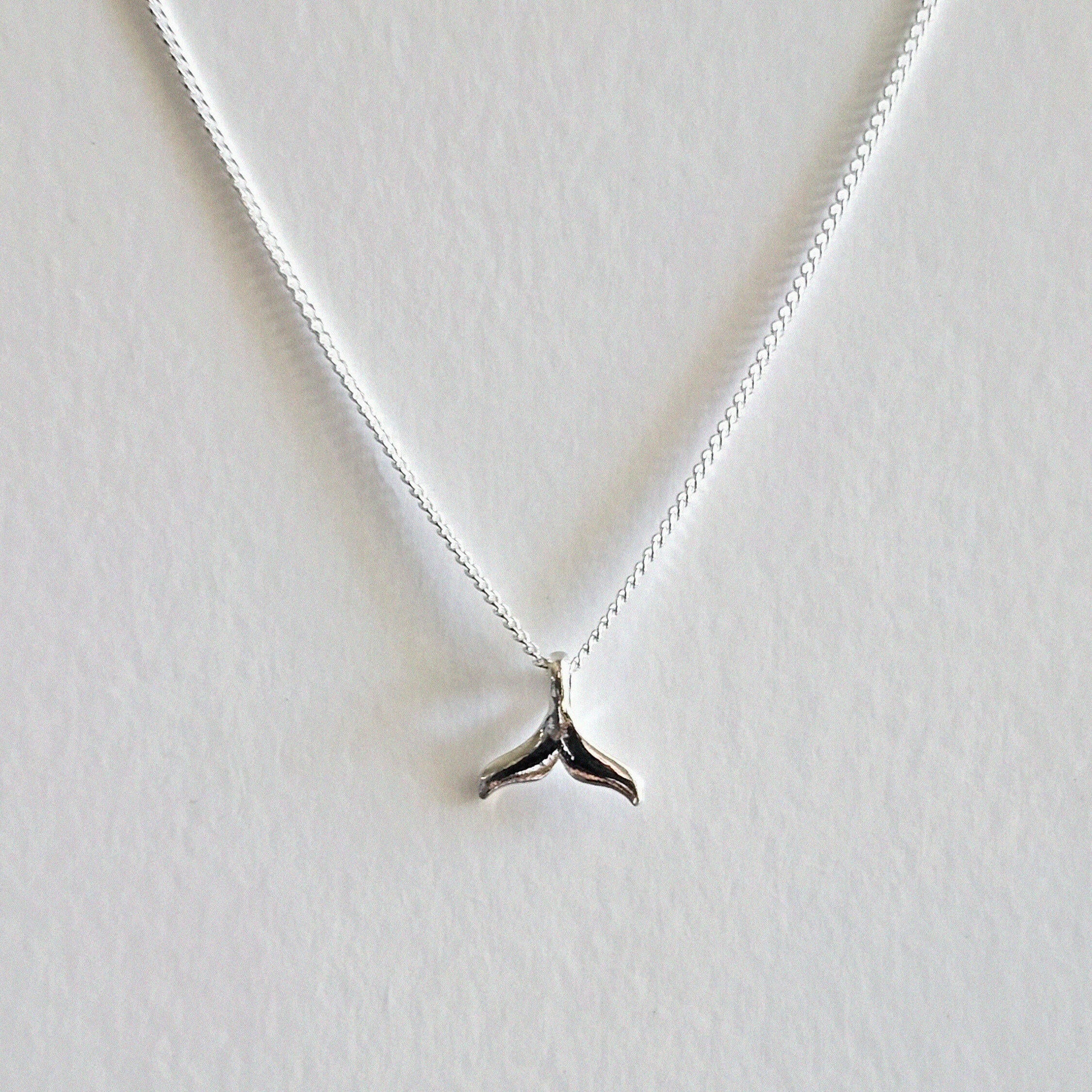 Dainty whale tail pendant with sleek chain, ocean charm jewelry inspired by marine life