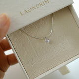 Silver necklace with a pendant in an open jewelry box labeled 'Laondrim'.