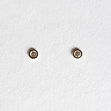 Front view of Bishop Circle Studs with centered CZ in 10K gold