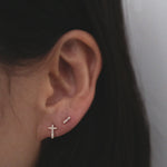 Model styling CZ line studs with minimalist cross studs for a modern look