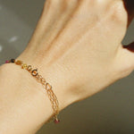 Side angle wrist shot showing clasp and colorful tourmaline stones