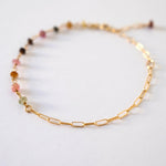 Close-up of tourmaline beads and gold links