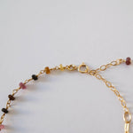 Detail of lobster clasp and final gemstone beads in focus