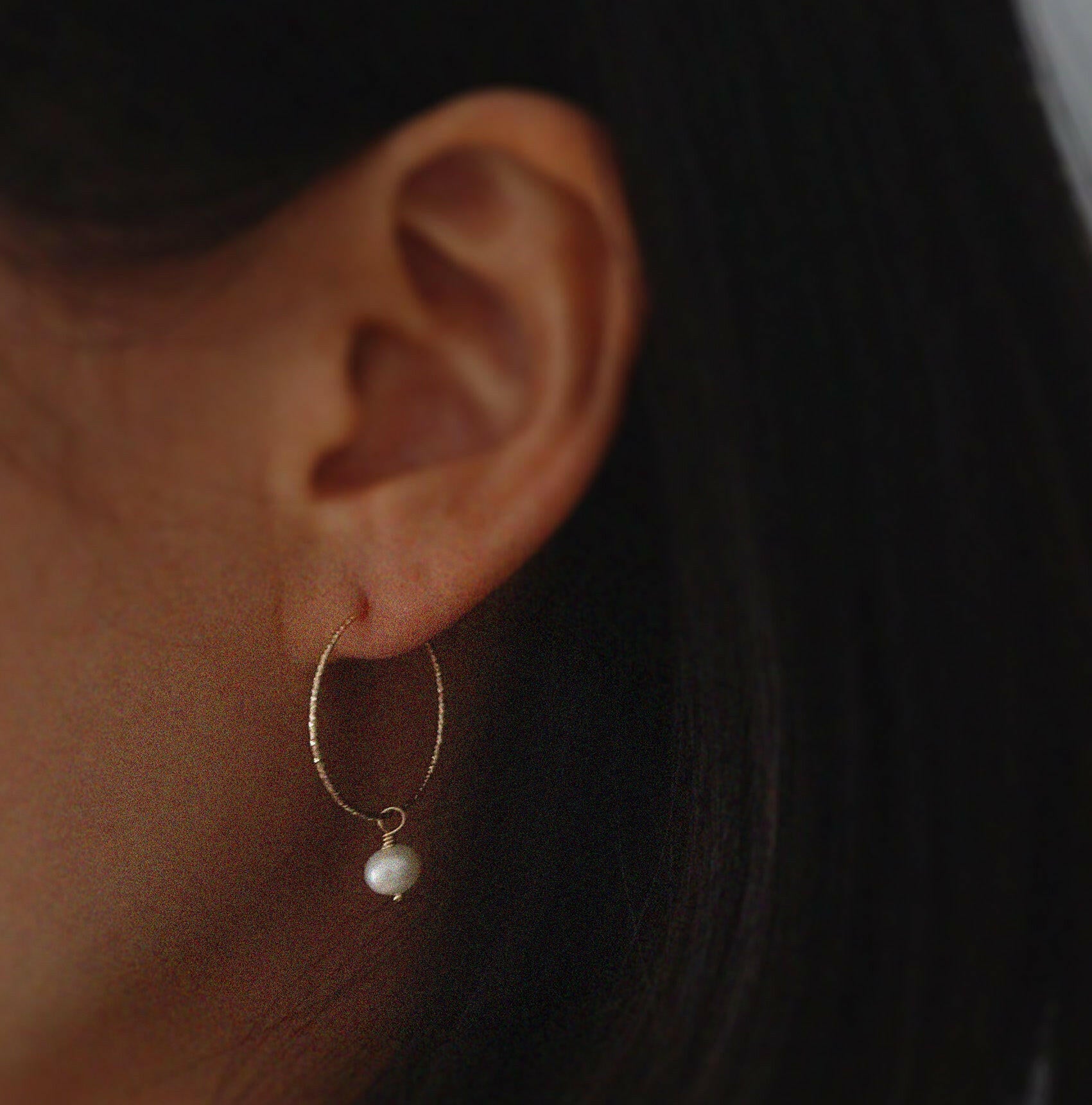 Model wearing Aster Hoops with freshwater pearl for a refined minimalist look