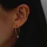 Model wearing Gold Filled Lei Moonstone Hoops for a subtle, calming look
