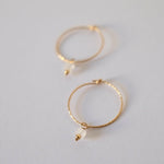 Side close-up of gold-filled hoop showing detailed moonstone setting