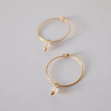 Side close-up of gold-filled hoop showing detailed moonstone setting
