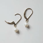 Close-up of Olivia Pearl Earring showing two of large pearl and smooth finish