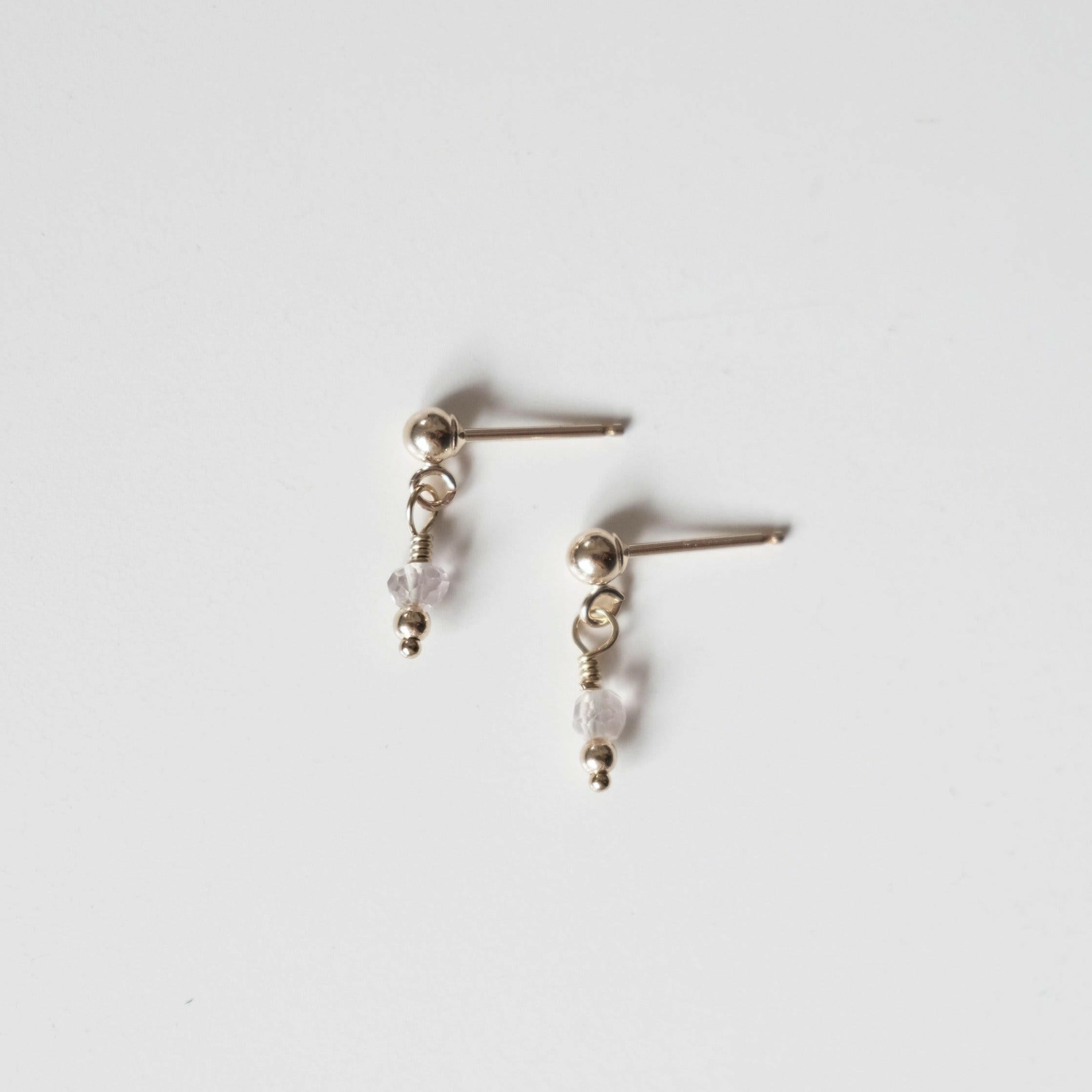 Petite gold drop earrings with small round clear quartz gemstones and gold posts