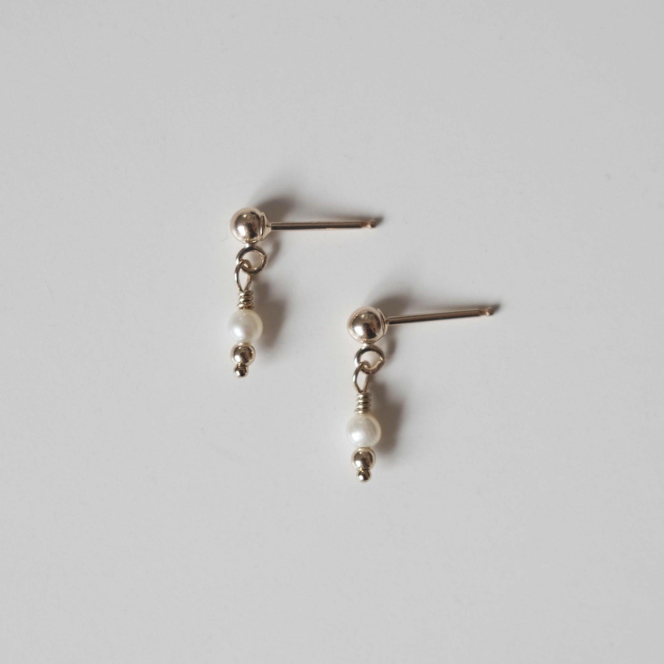 Petite gold drop earrings with small round freshwater pearl and gold posts
